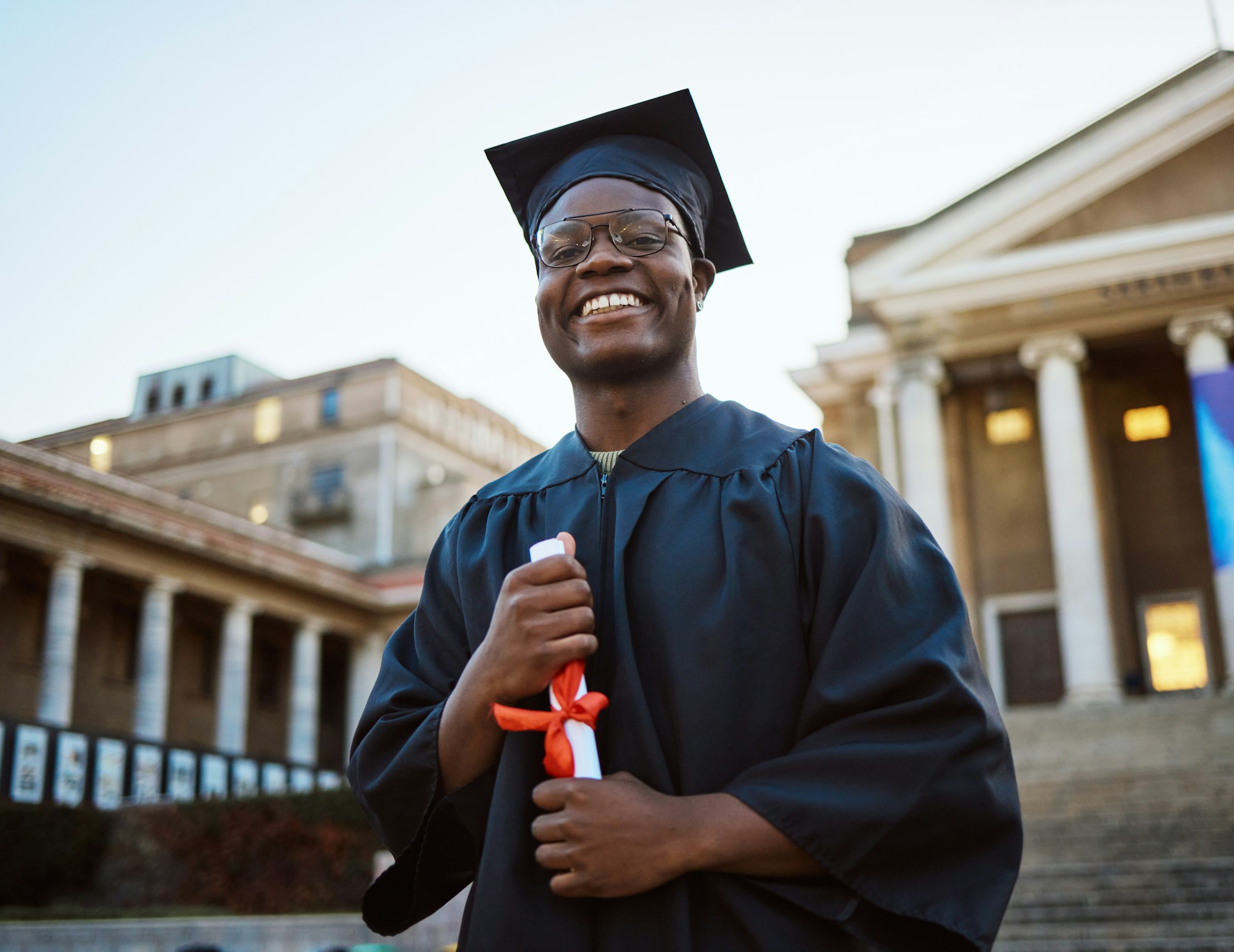 Achievement, diploma and portrait of a black man at graduation with college success, celebration an